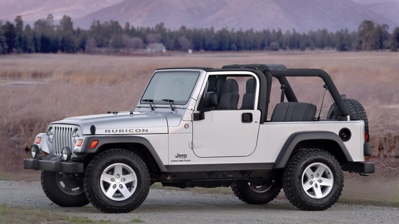 silver jeep rubicon in field
