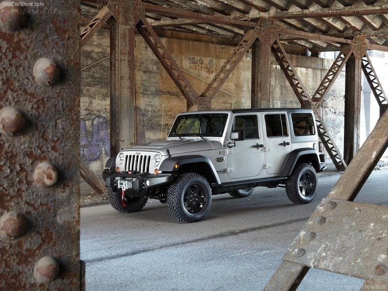 Silver Jeep Wrangler under bridge