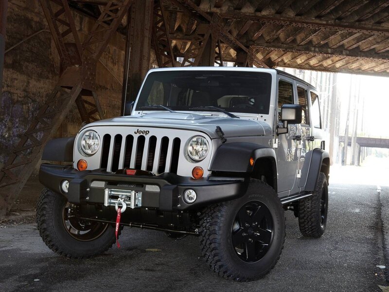 Silver Jeep Wrangler under bridge