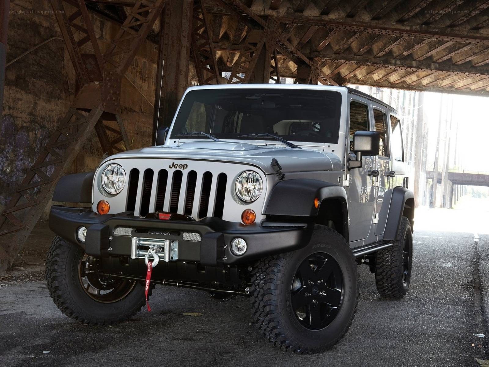 Silver Jeep Wrangler under bridge