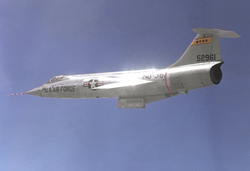 Silver Jet in Flight — Blue