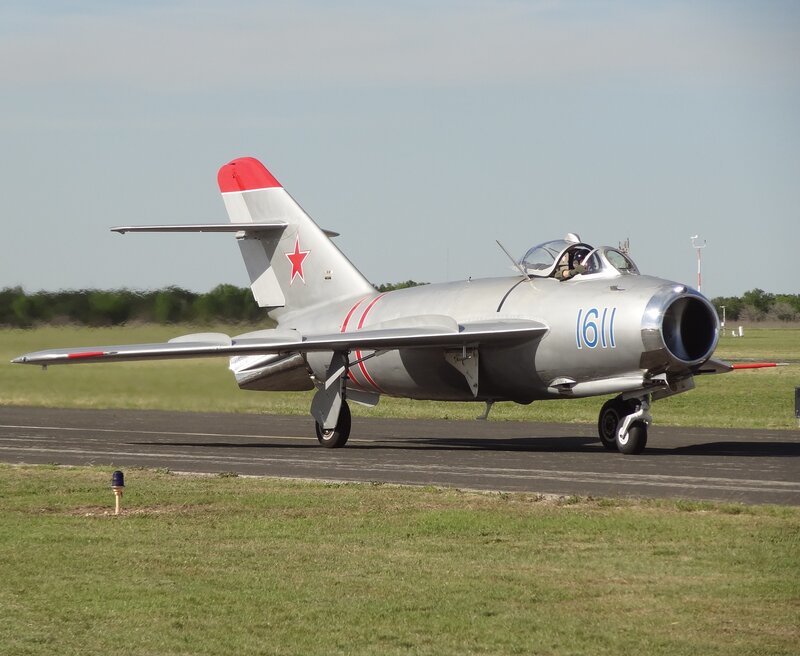 Silver Jet on Runway — Gray, Calm, Afternoon