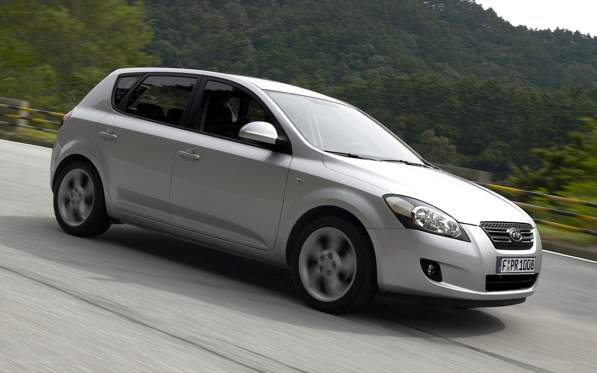silver kia cee'd driving on road