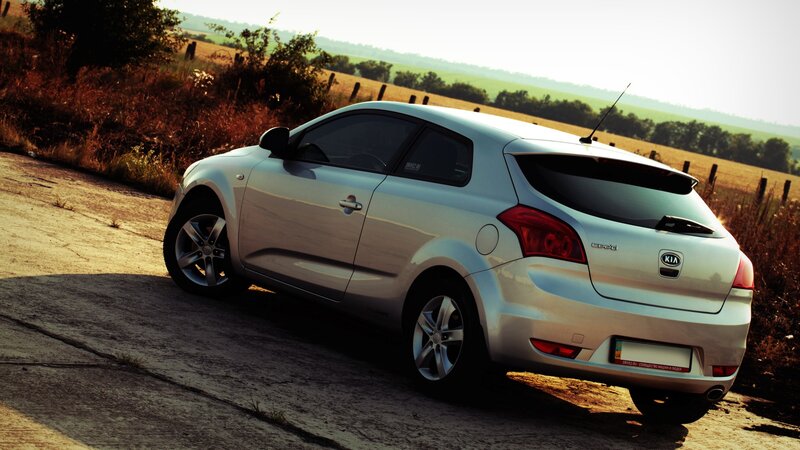 silver kia cee'd on rural road