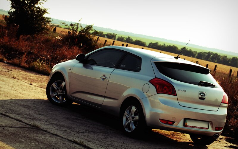 silver kia cee'd on rural road