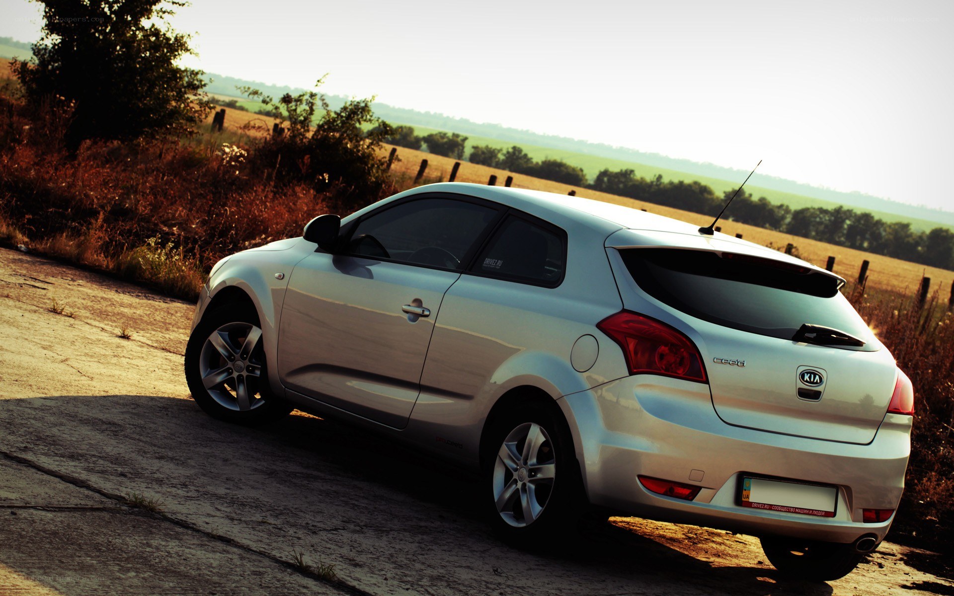silver kia cee'd on rural road