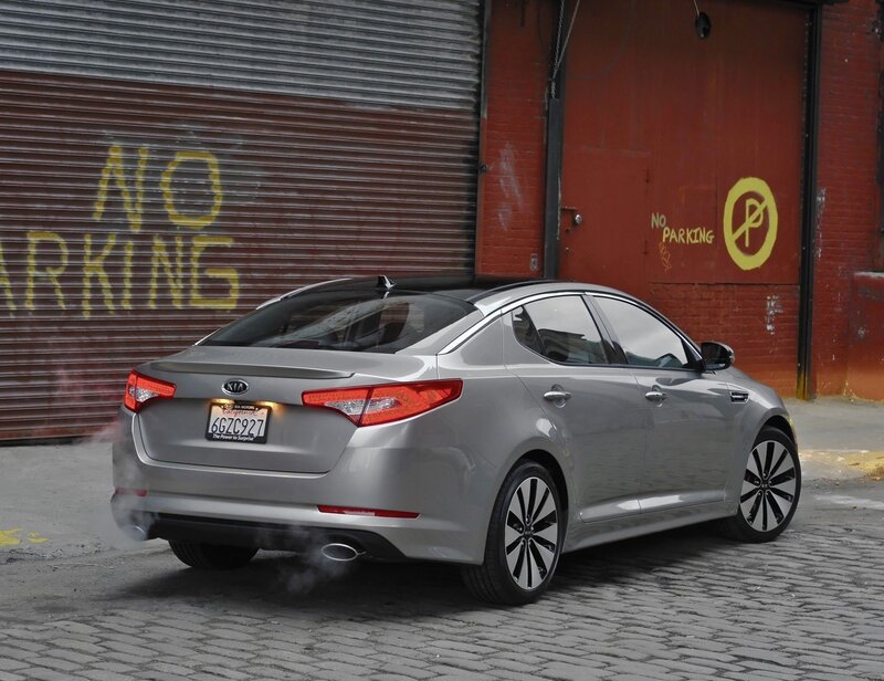 Silver Kia Optima parked in alley