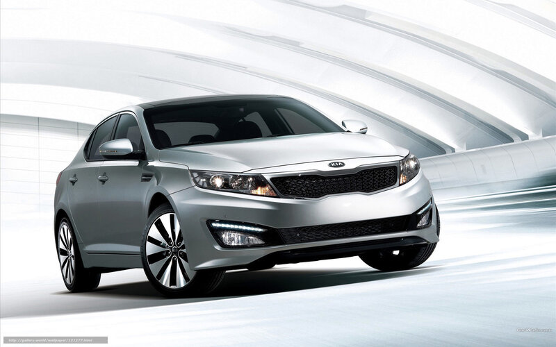 Silver Kia sedan in motion