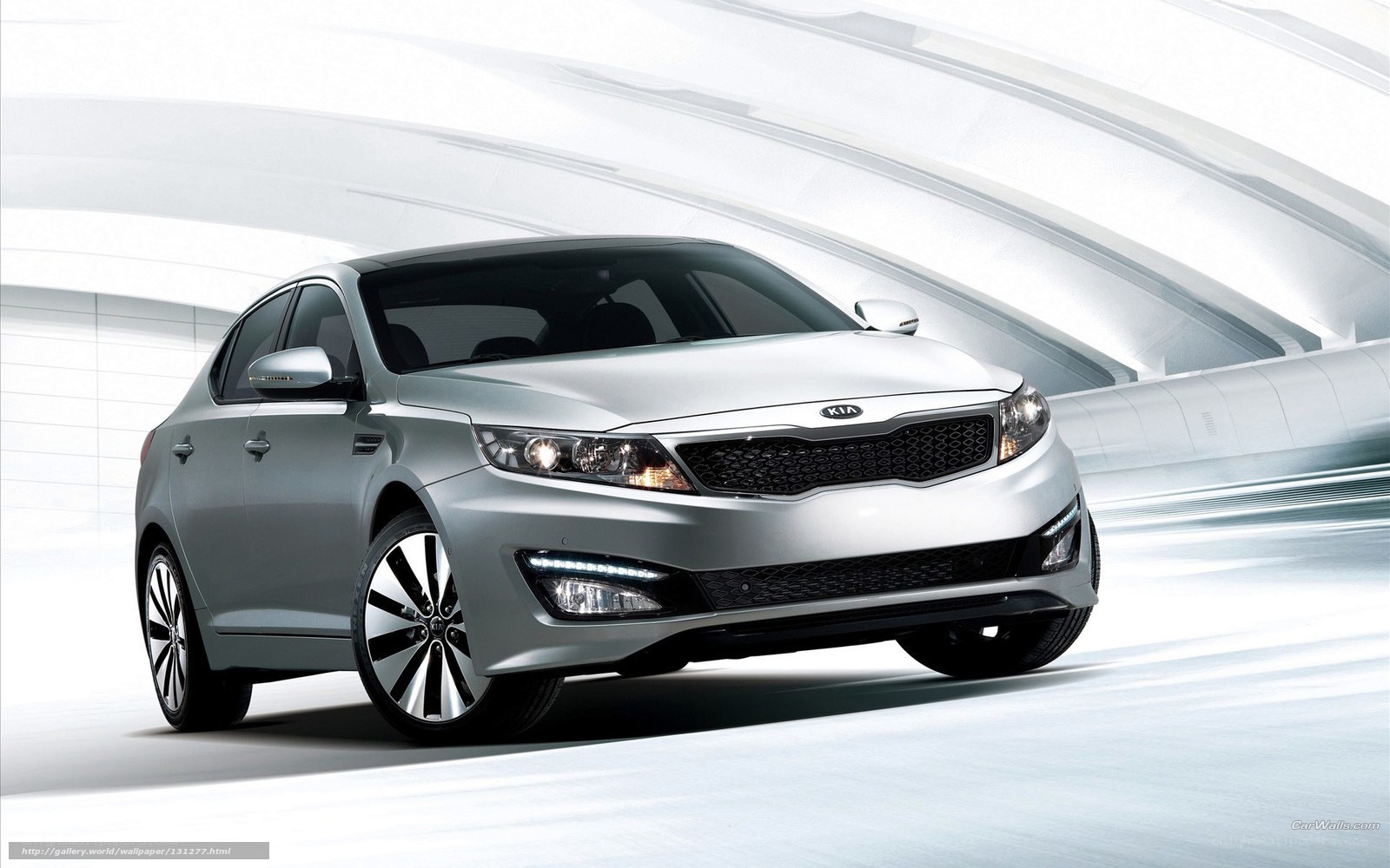 Silver Kia sedan in motion