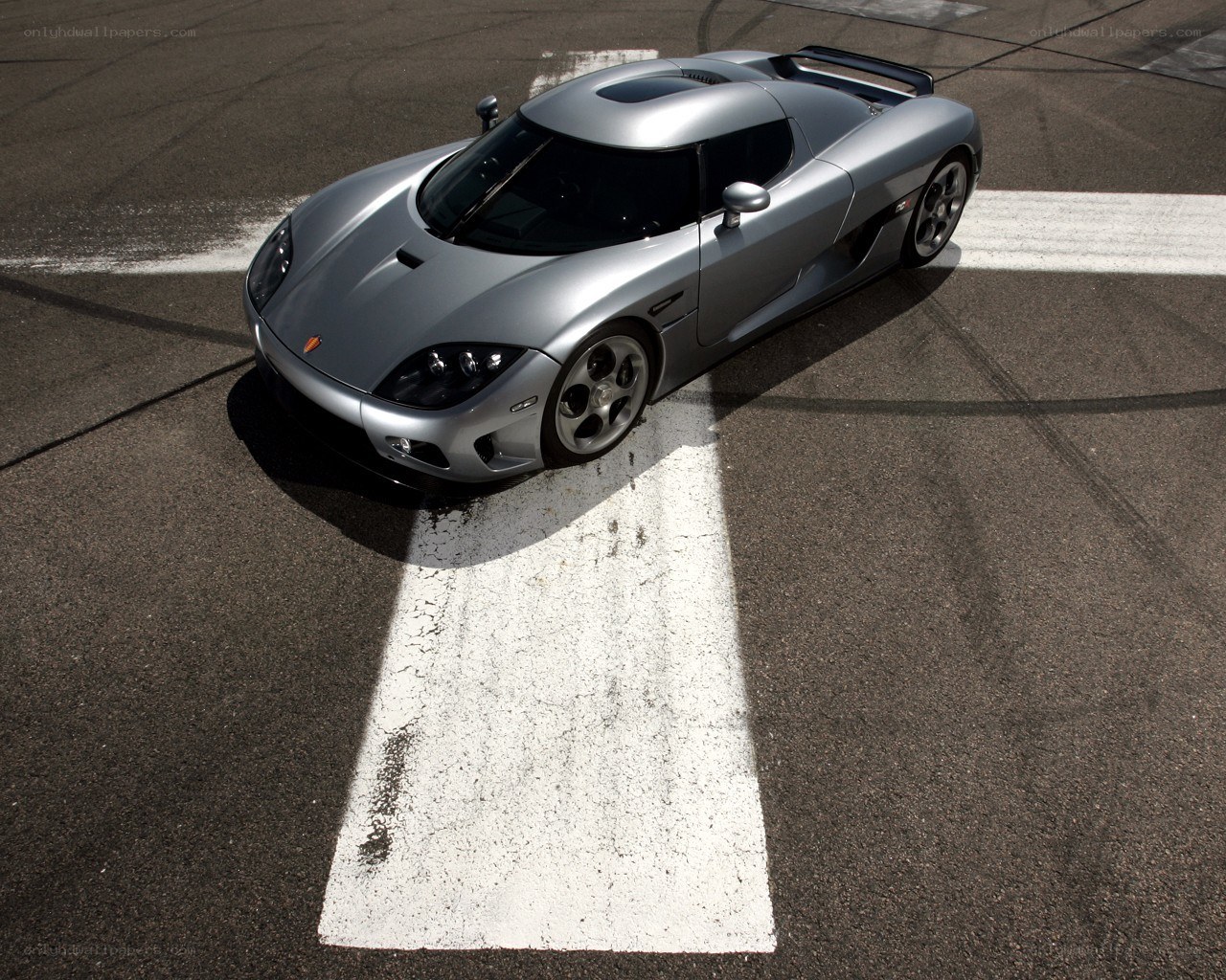 Silver Koenigsegg on racetrack