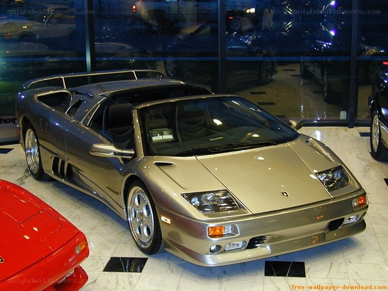 silver lamborghini in showroom