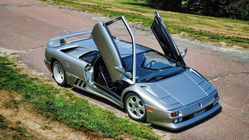 silver lamborghini with doors open