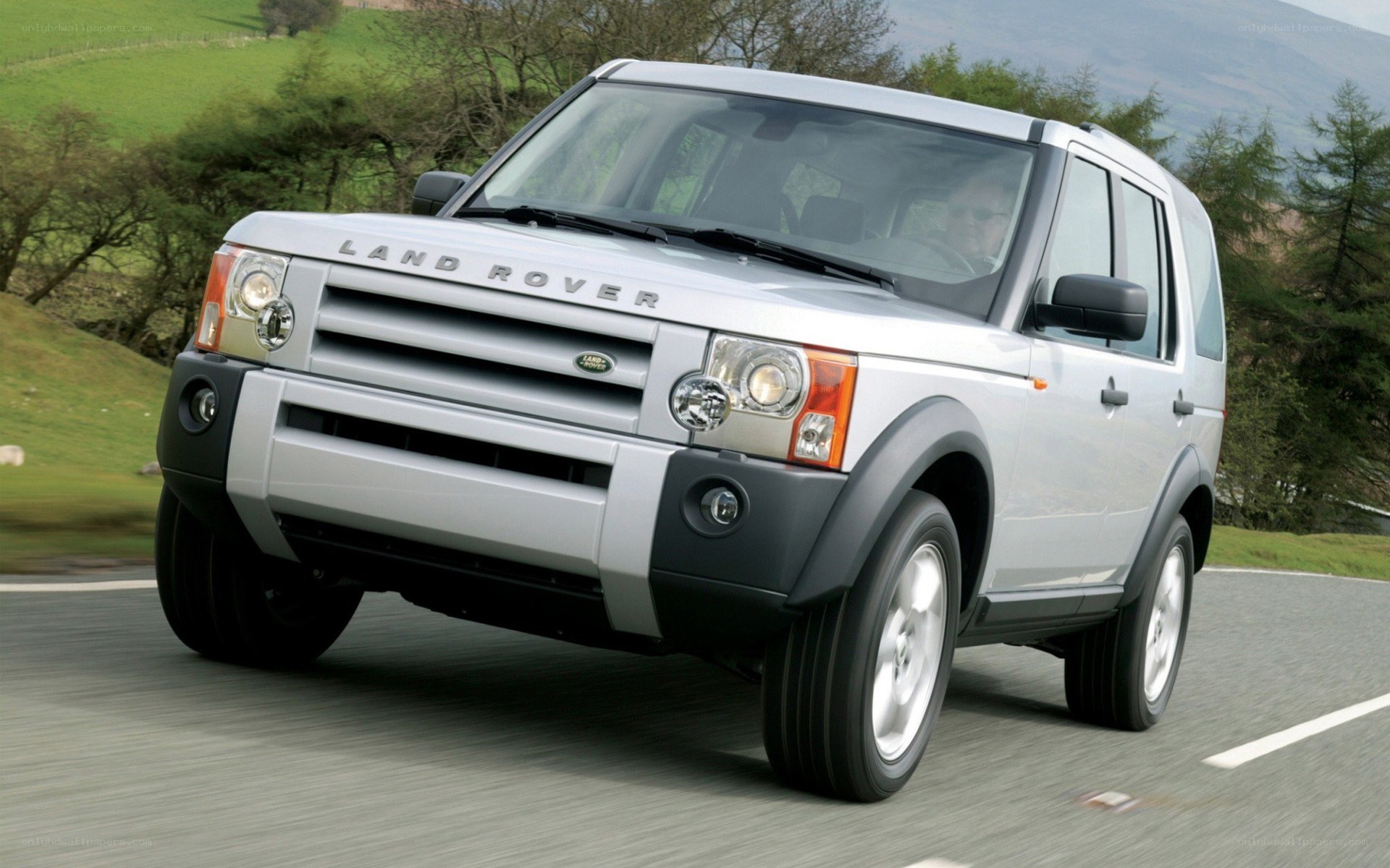 Silver Land Rover Discovery driving