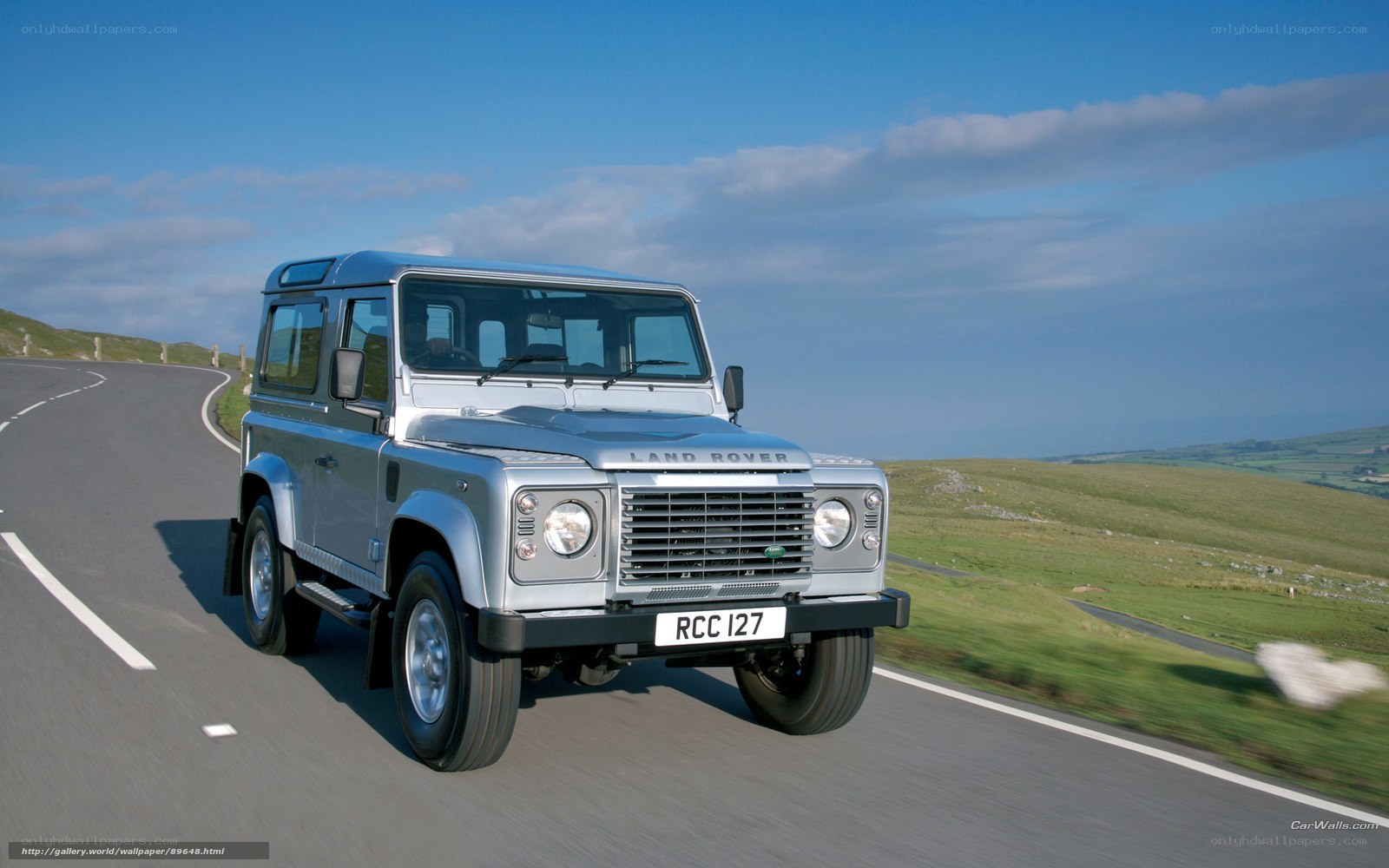 Silver Land Rover driving on road
