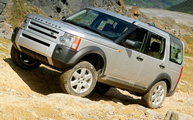 Silver Land Rover on rocky terrain