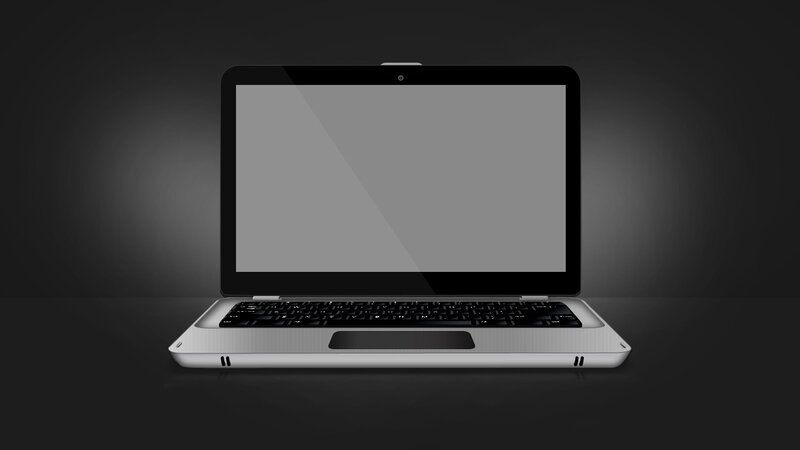 silver laptop on dark background