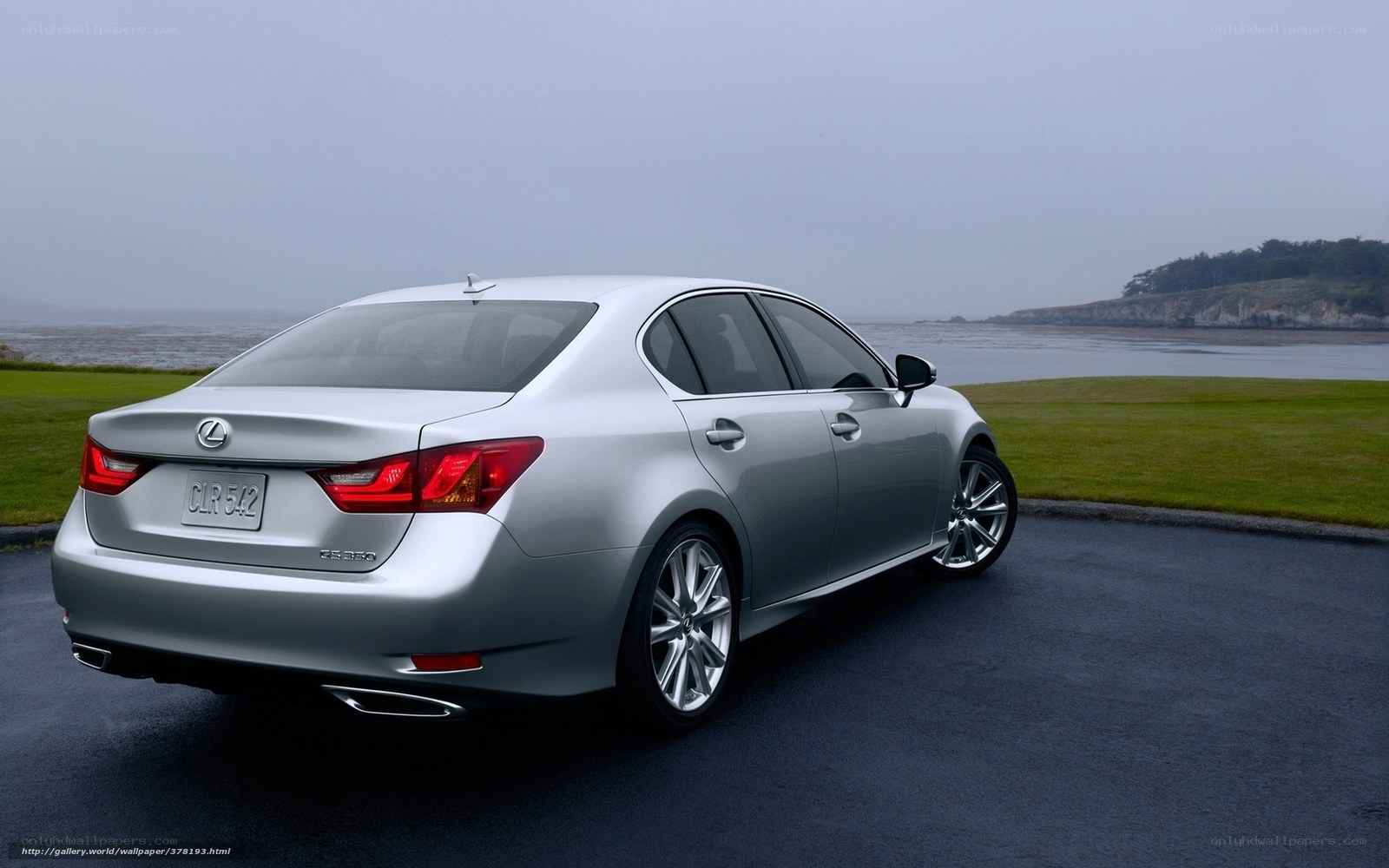 Silver Lexus CLS parked by the coast