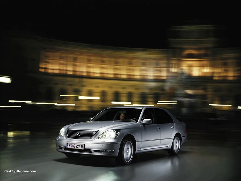 Silver Lexus driving at night