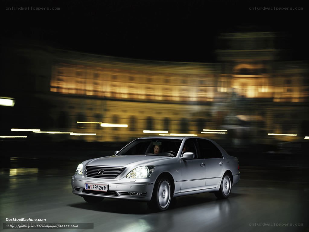 Silver Lexus driving at night