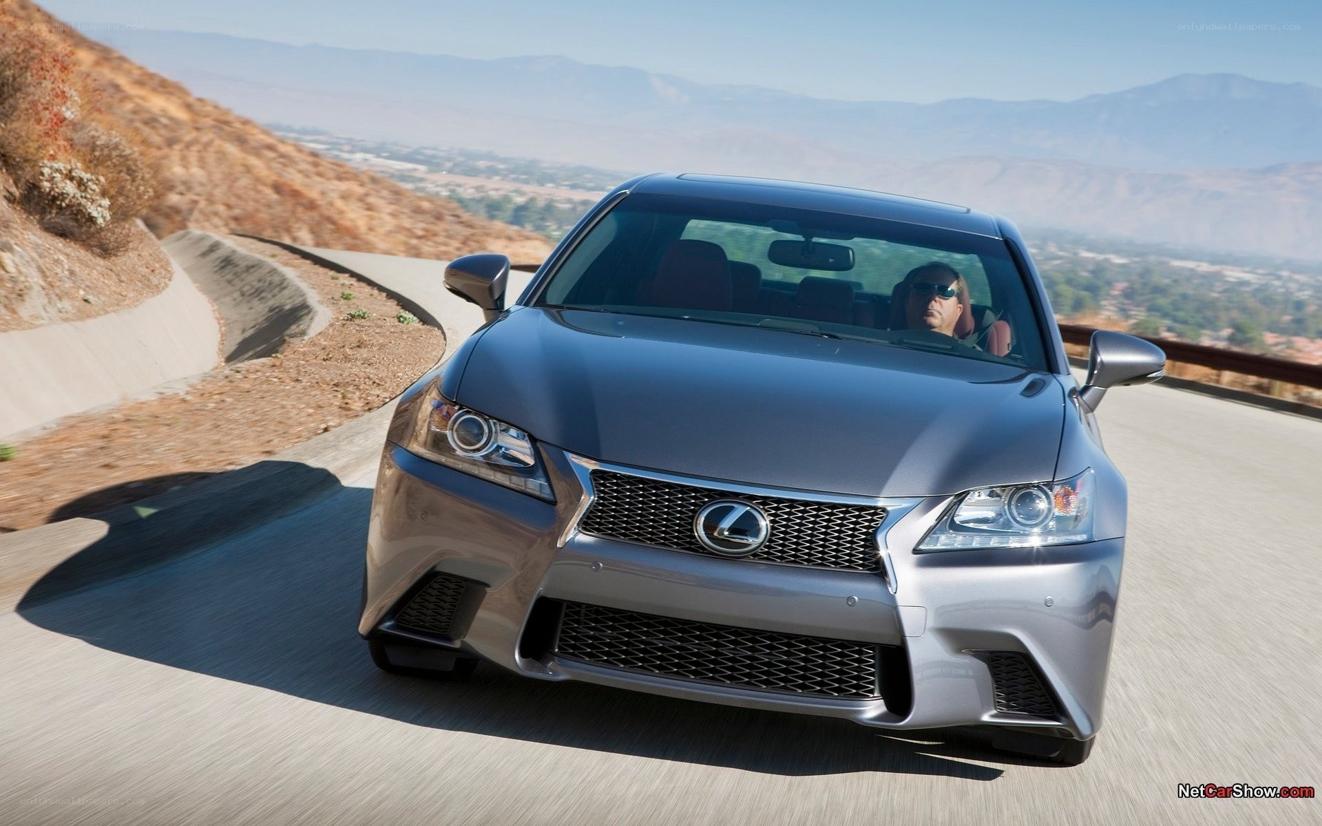 silver lexus driving on mountain road