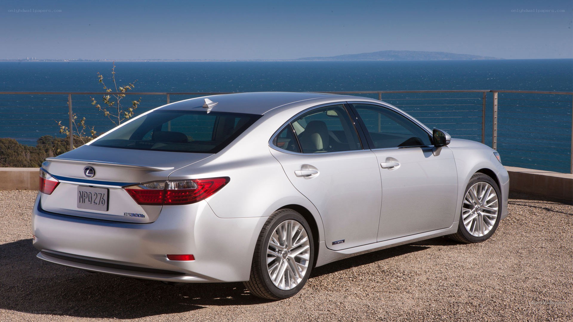 Silver Lexus ES300h by the sea