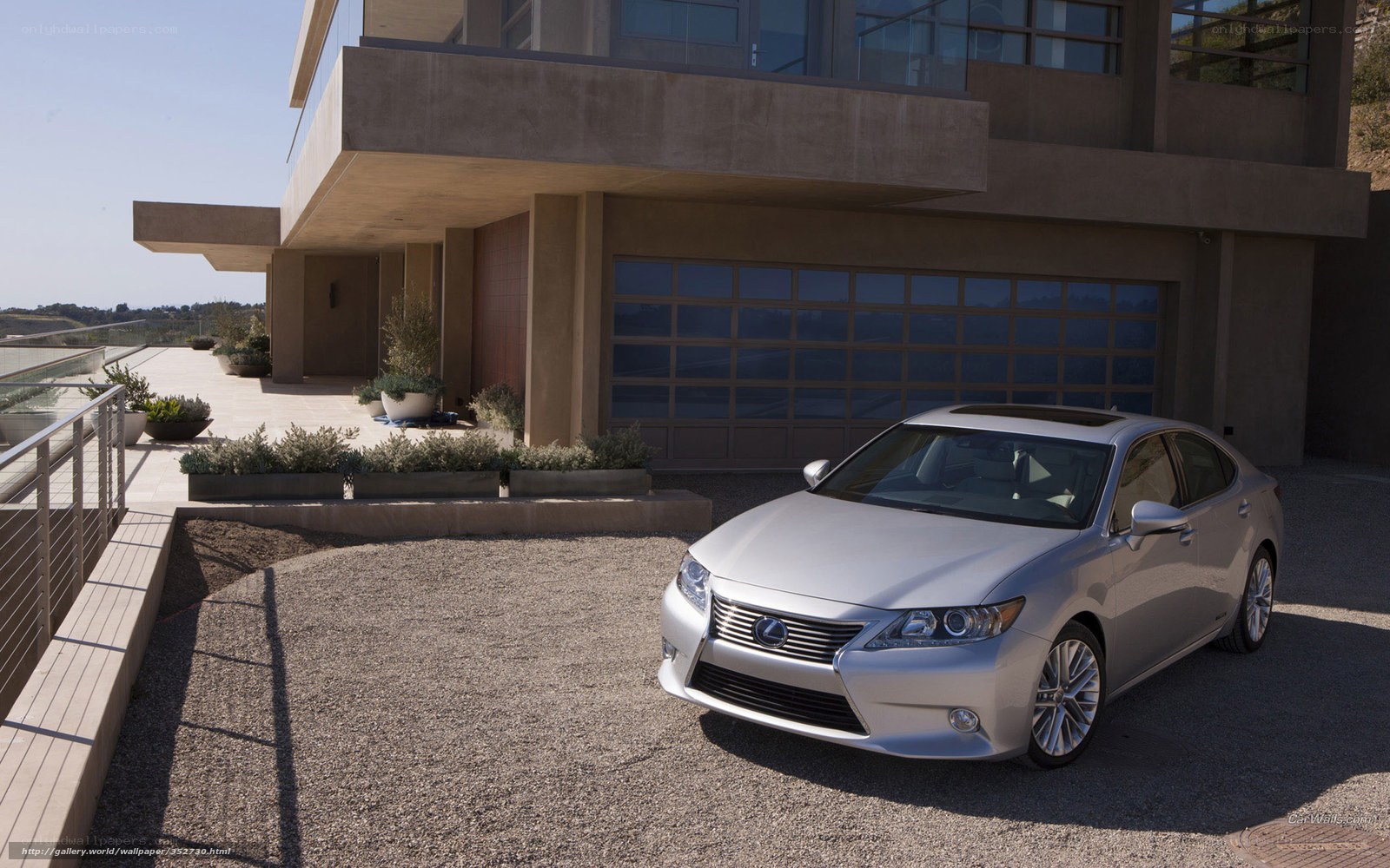 Silver Lexus GS in front of modern home