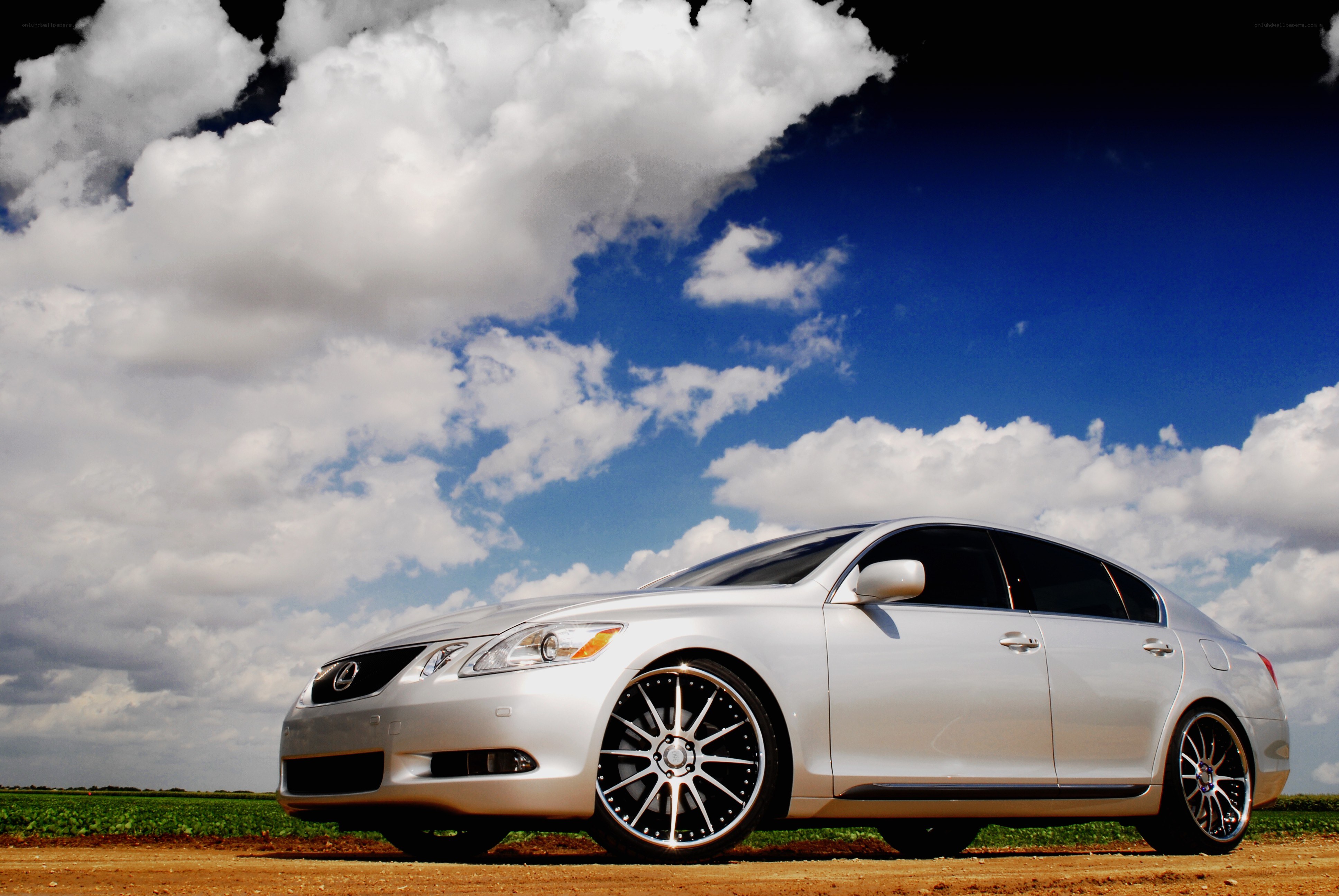 Silver Lexus GS on a dirt road
