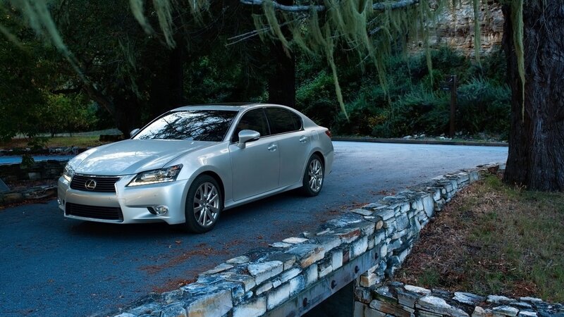 Silver Lexus GS on a forest road