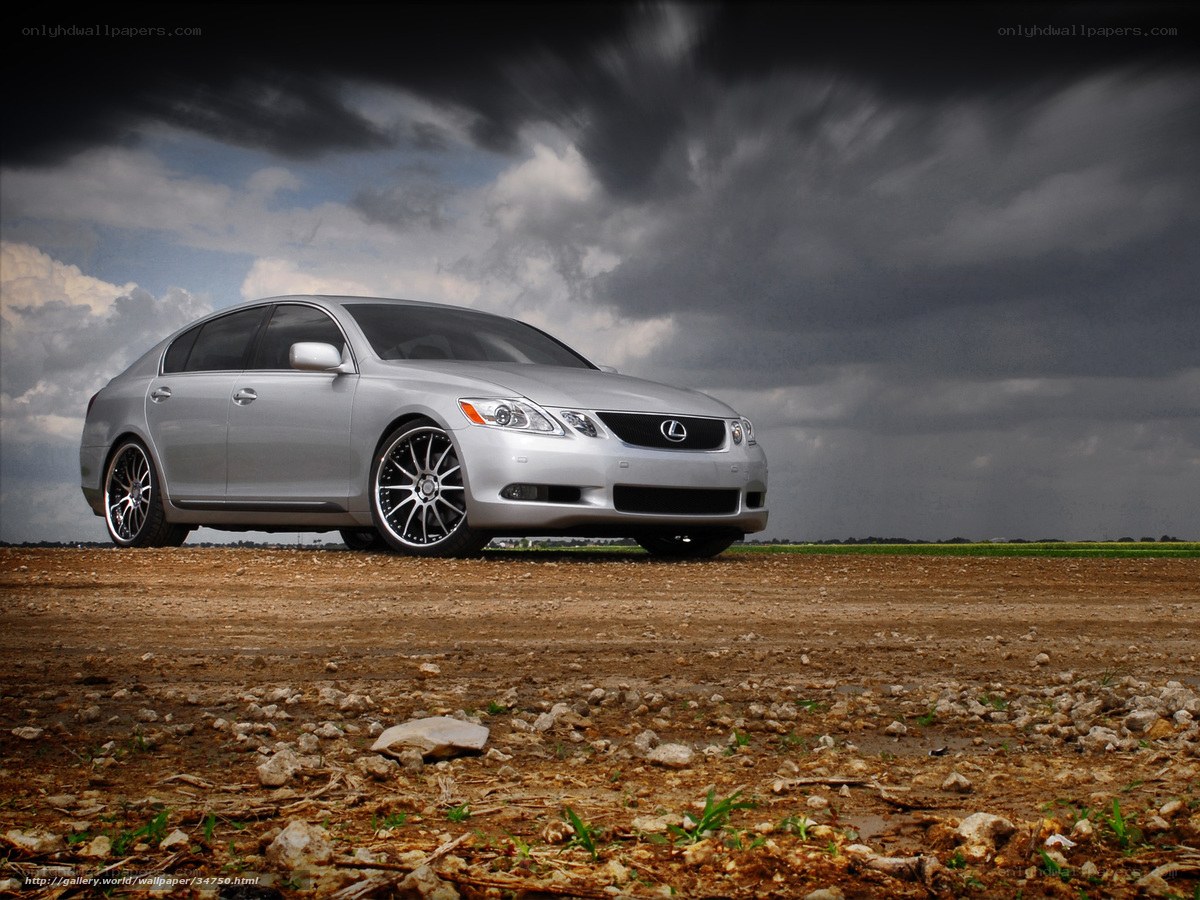 Silver Lexus GS on dirt field