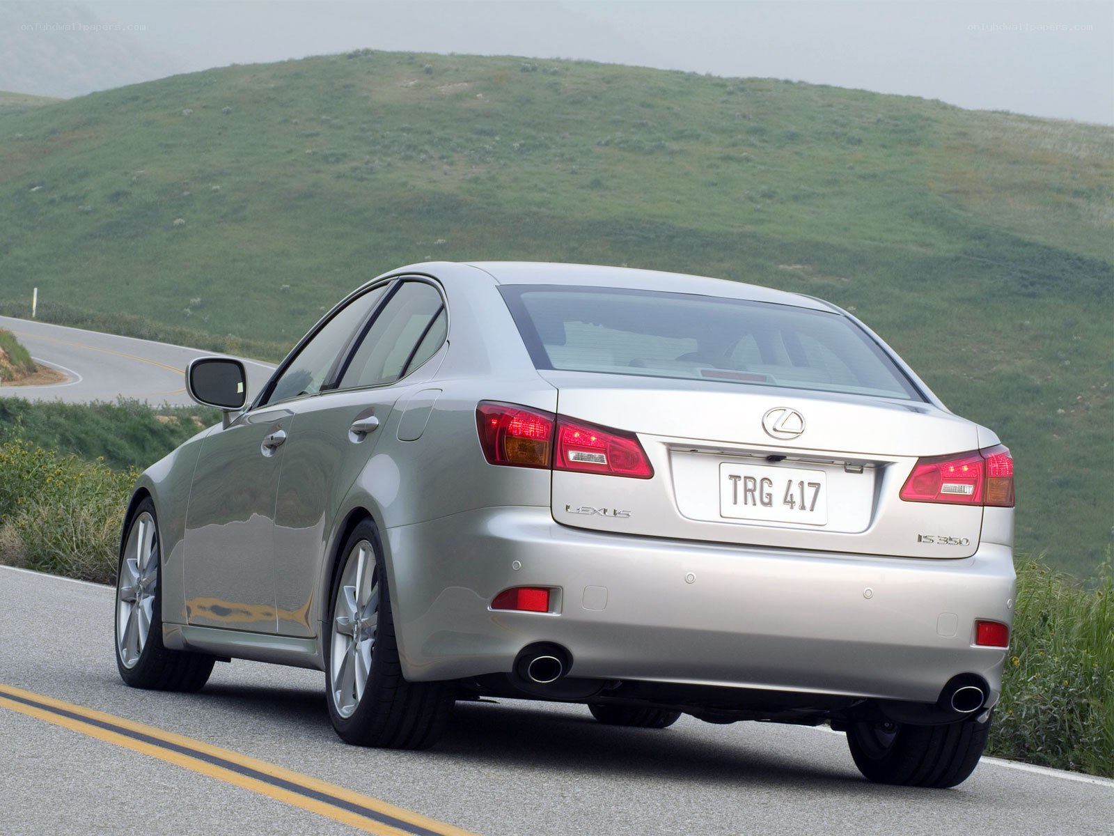 silver lexus is driving on road