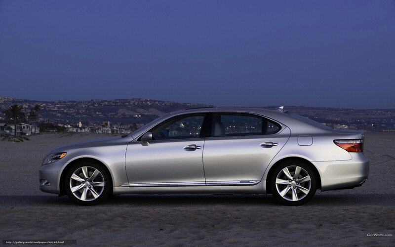 Silver Lexus LS on beach at dusk