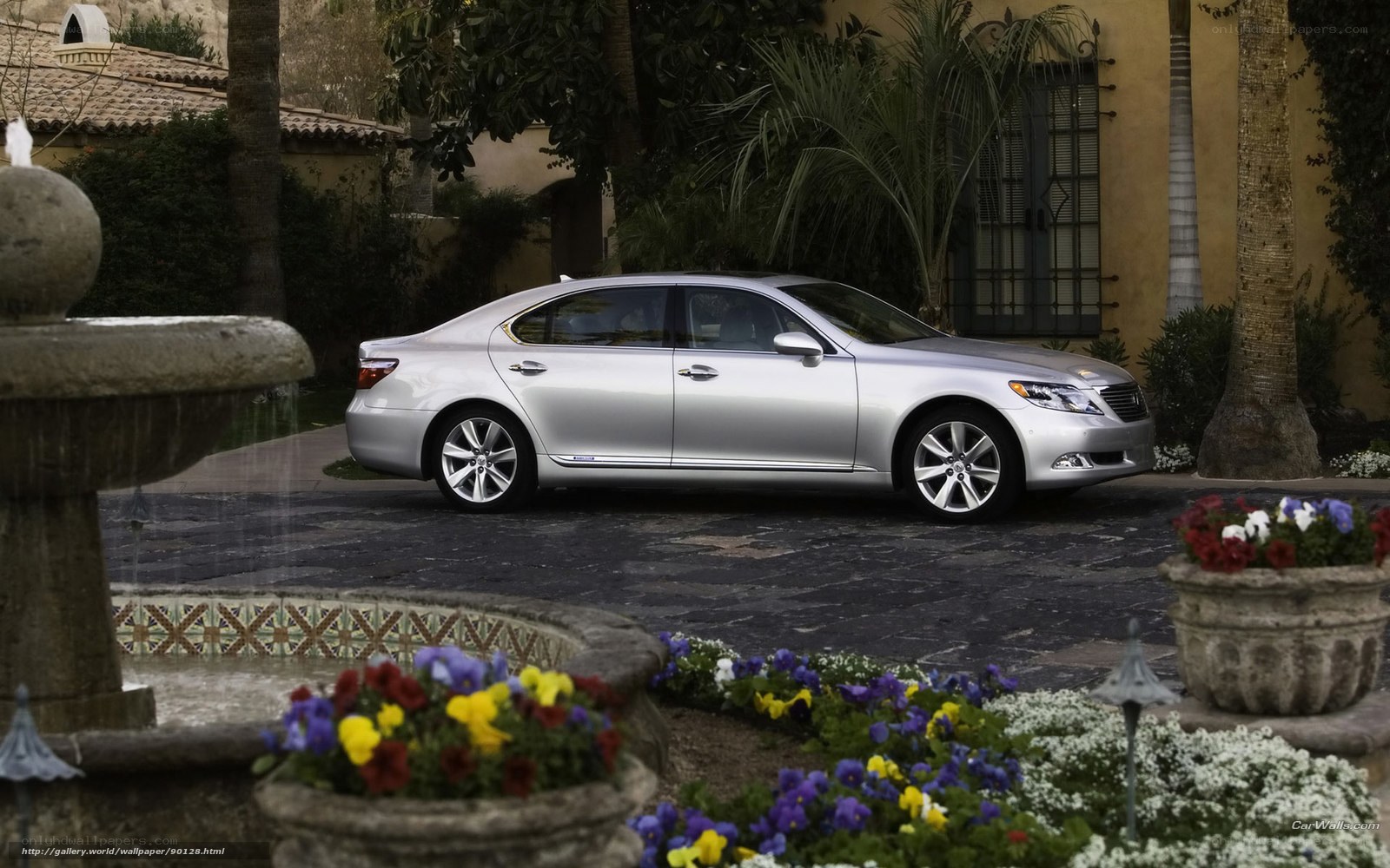 Silver Lexus LS sedan in garden