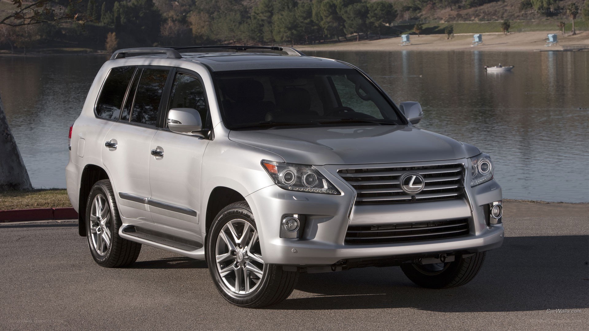 Silver Lexus LX SUV by lake