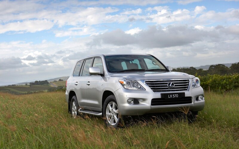 Silver Lexus LX570 in a field