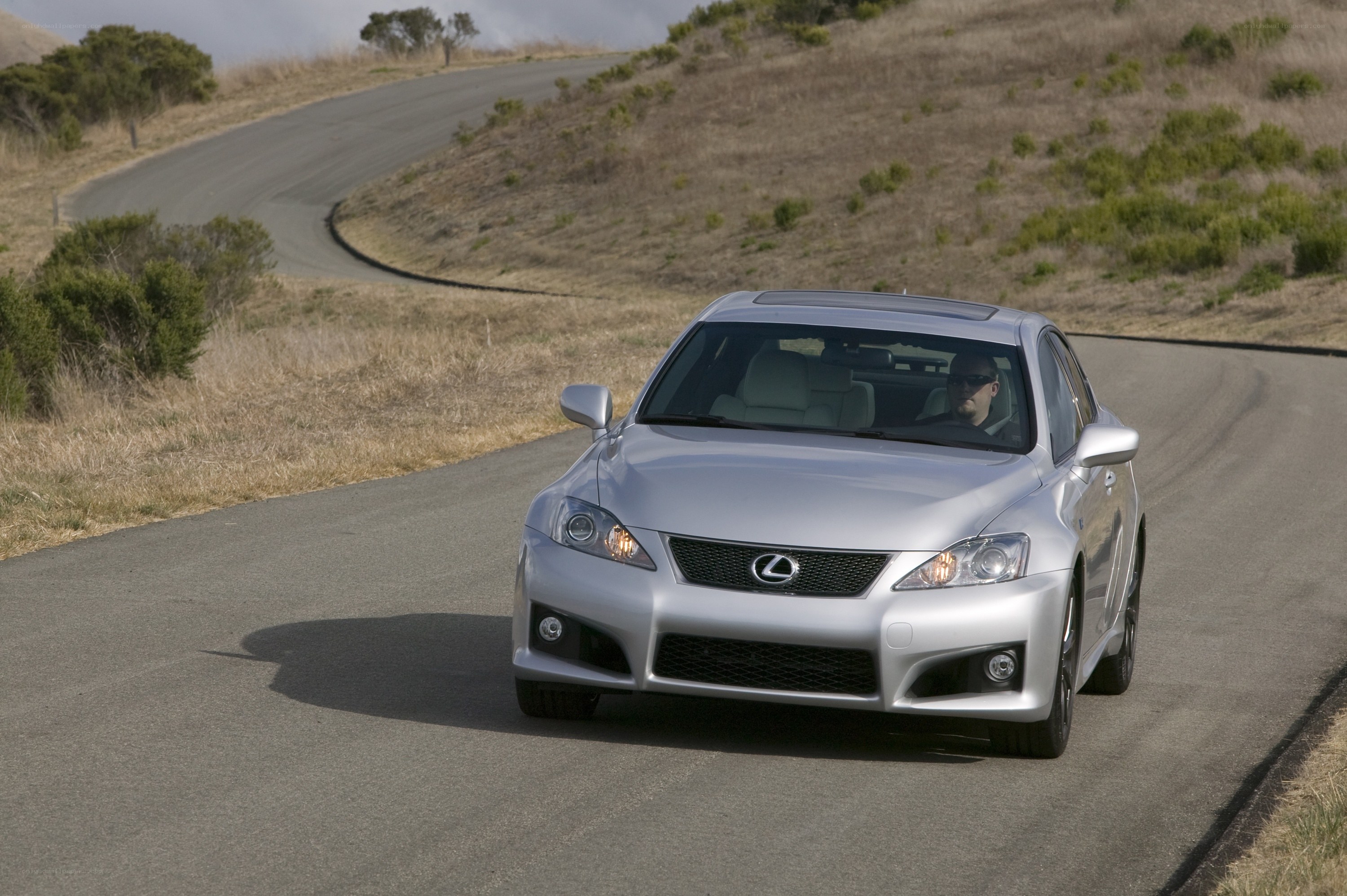 silver lexus on winding road
