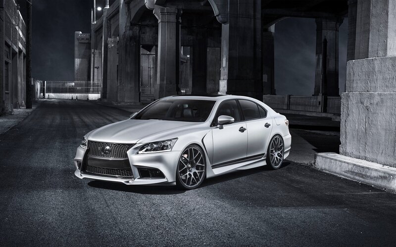 Silver Lexus under a bridge