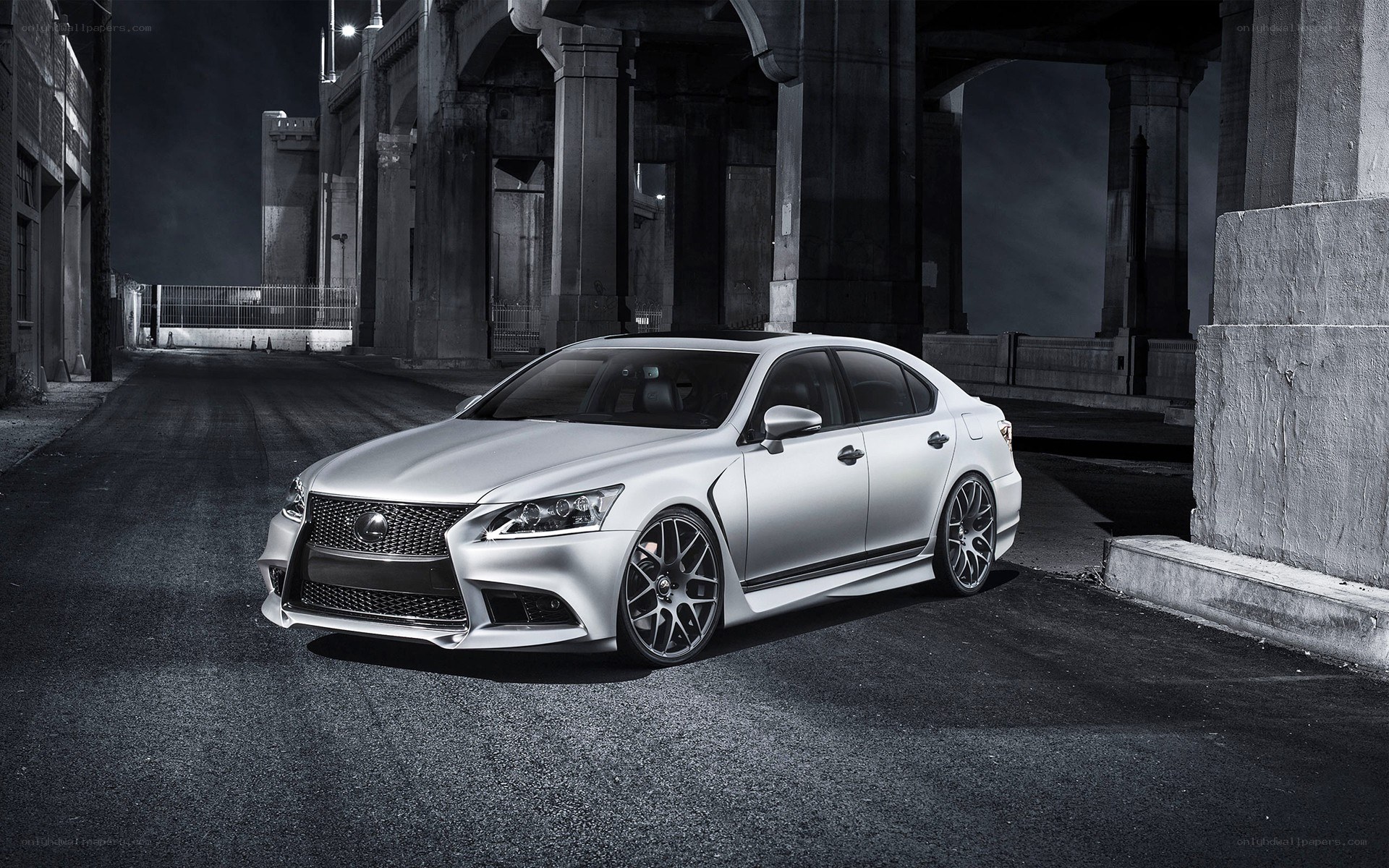 Silver Lexus under a bridge