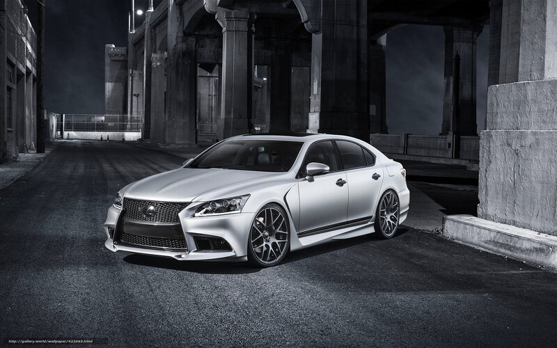 Silver Lexus under bridge at night