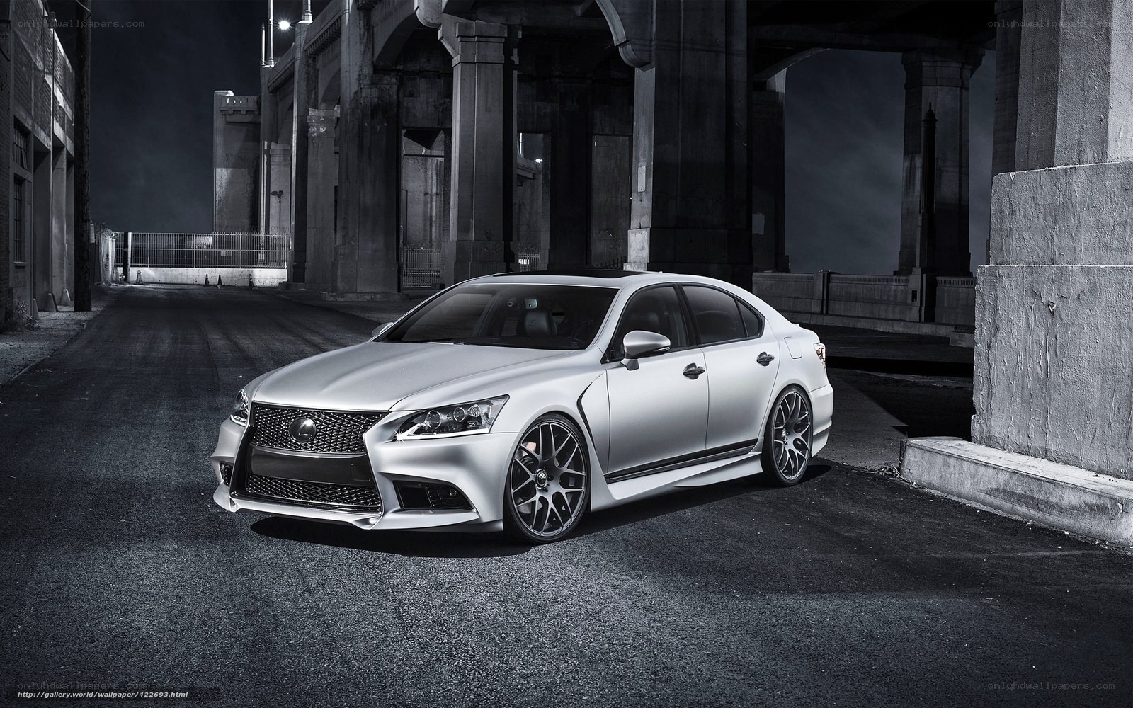 Silver Lexus under bridge at night