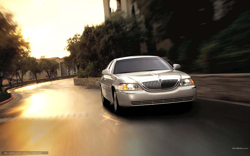 silver lincoln driving on road