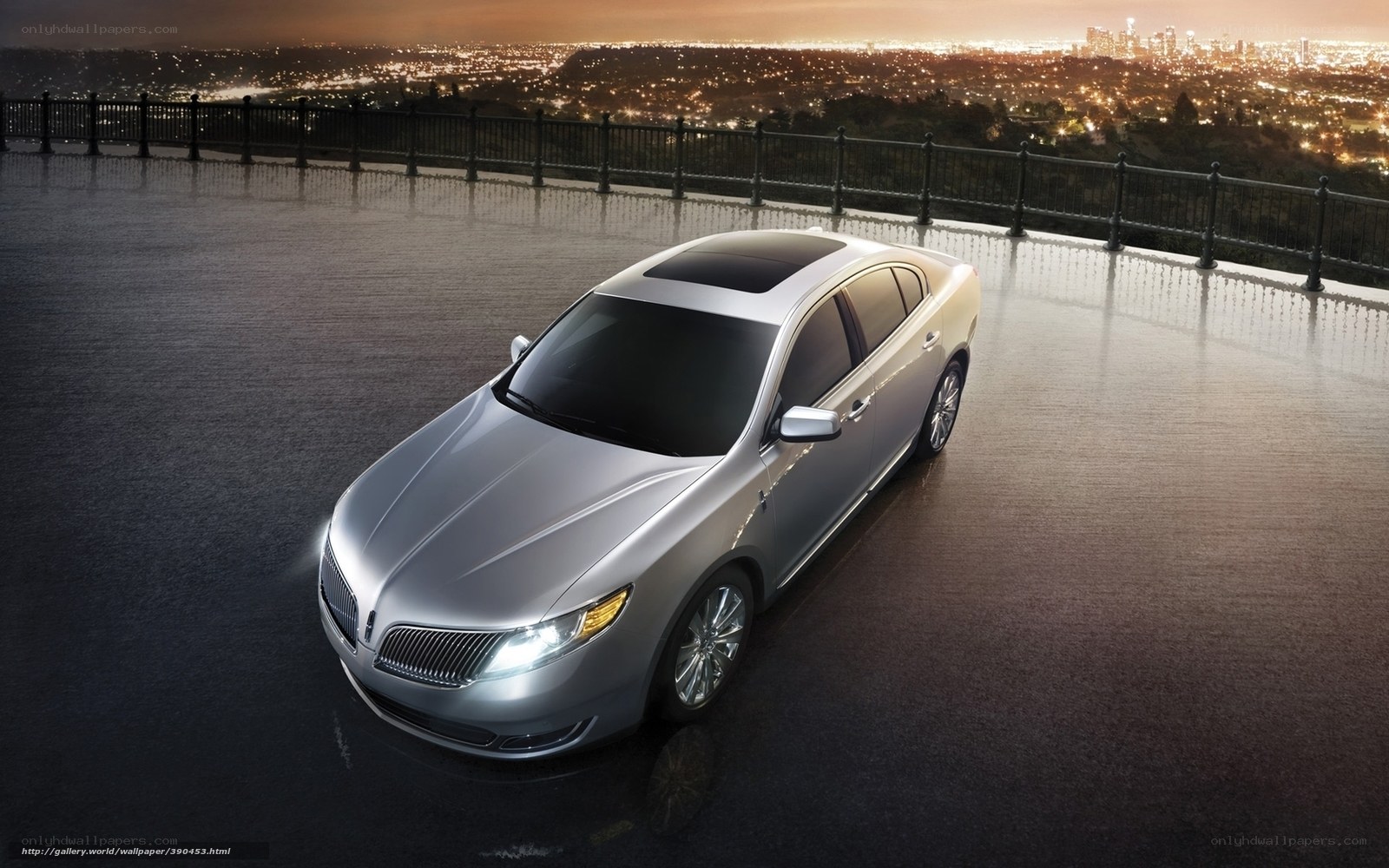 Silver Lincoln sedan at night