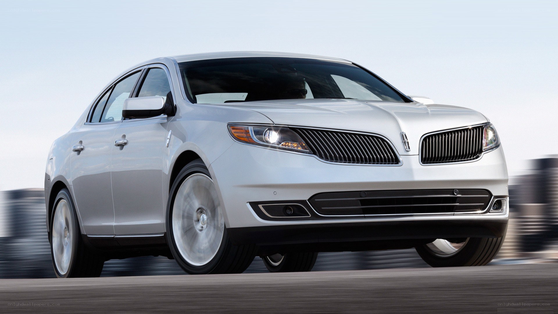 silver lincoln sedan in motion