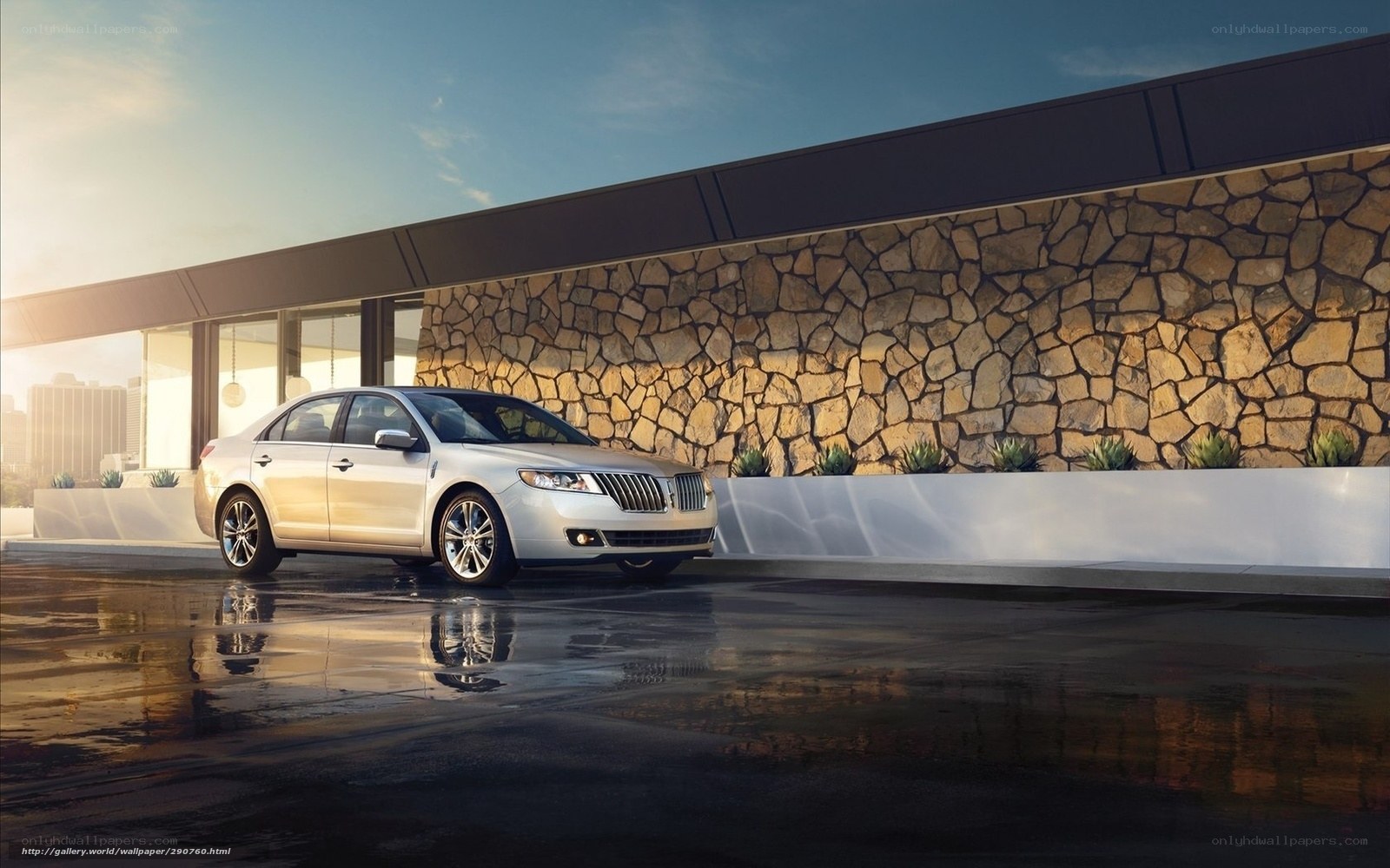 Silver Lincoln sedan on wet pavement