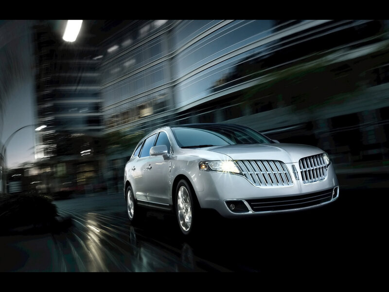 Silver Lincoln SUV in city