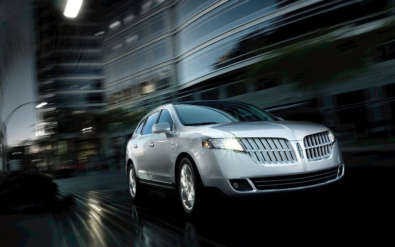 Silver Lincoln SUV in motion