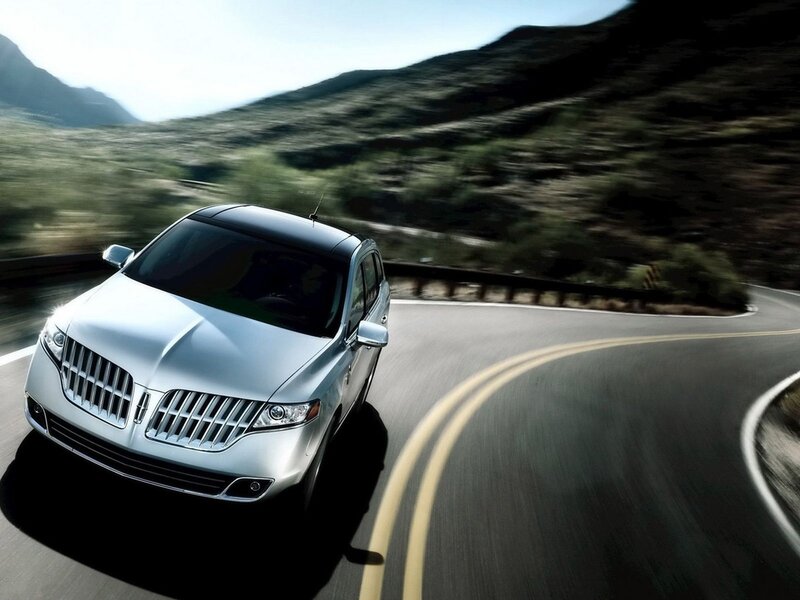 silver lincoln suv on winding road