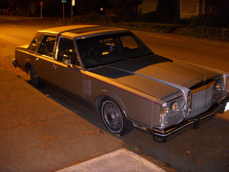 silver lincoln town car at night