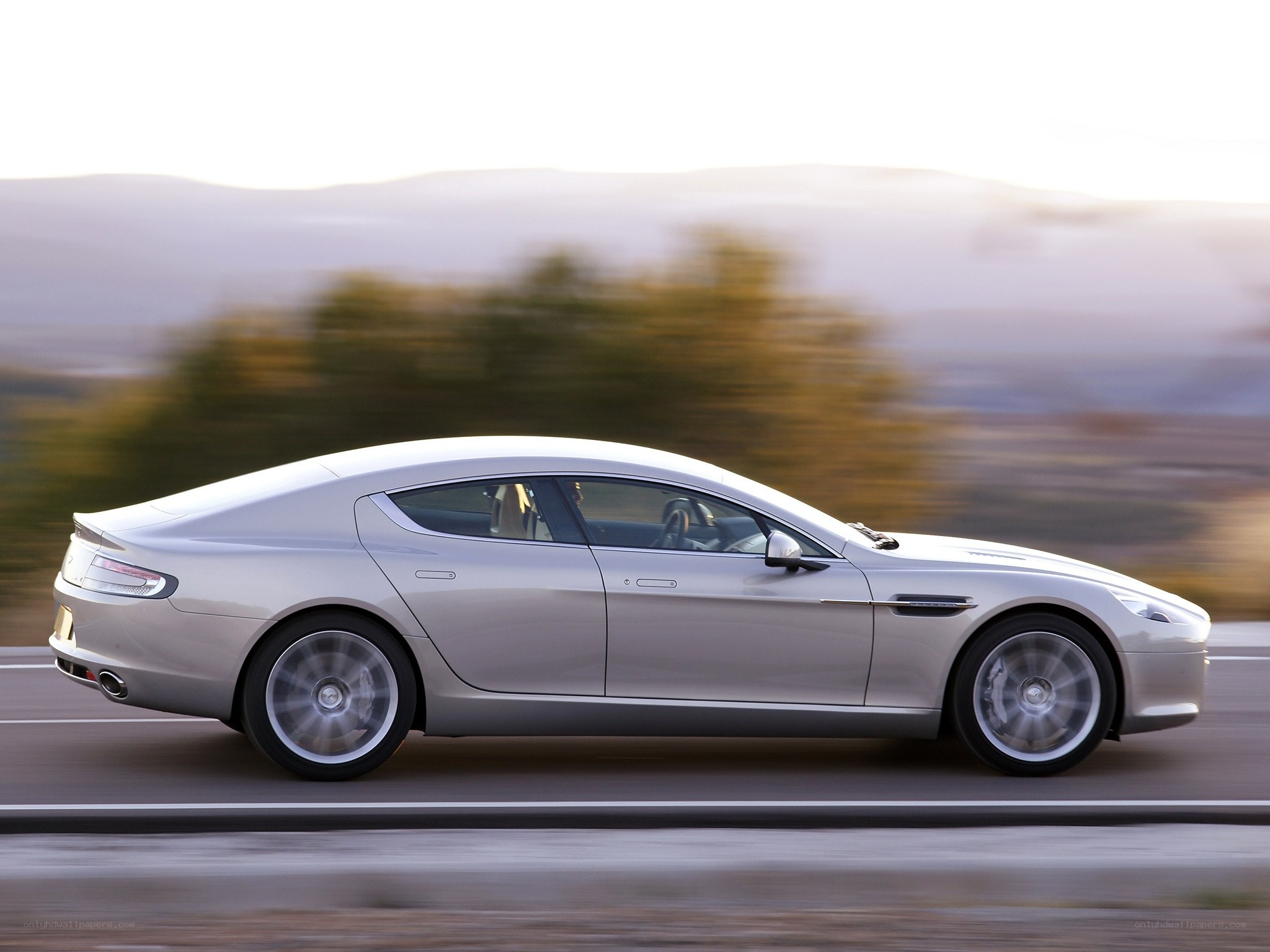 silver luxury car in motion