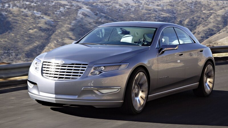 silver luxury sedan on mountain road