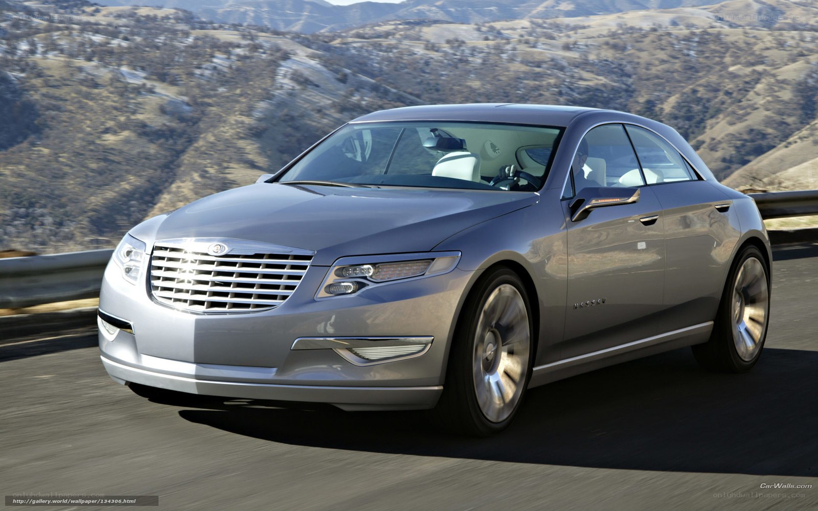 silver luxury sedan on mountain road